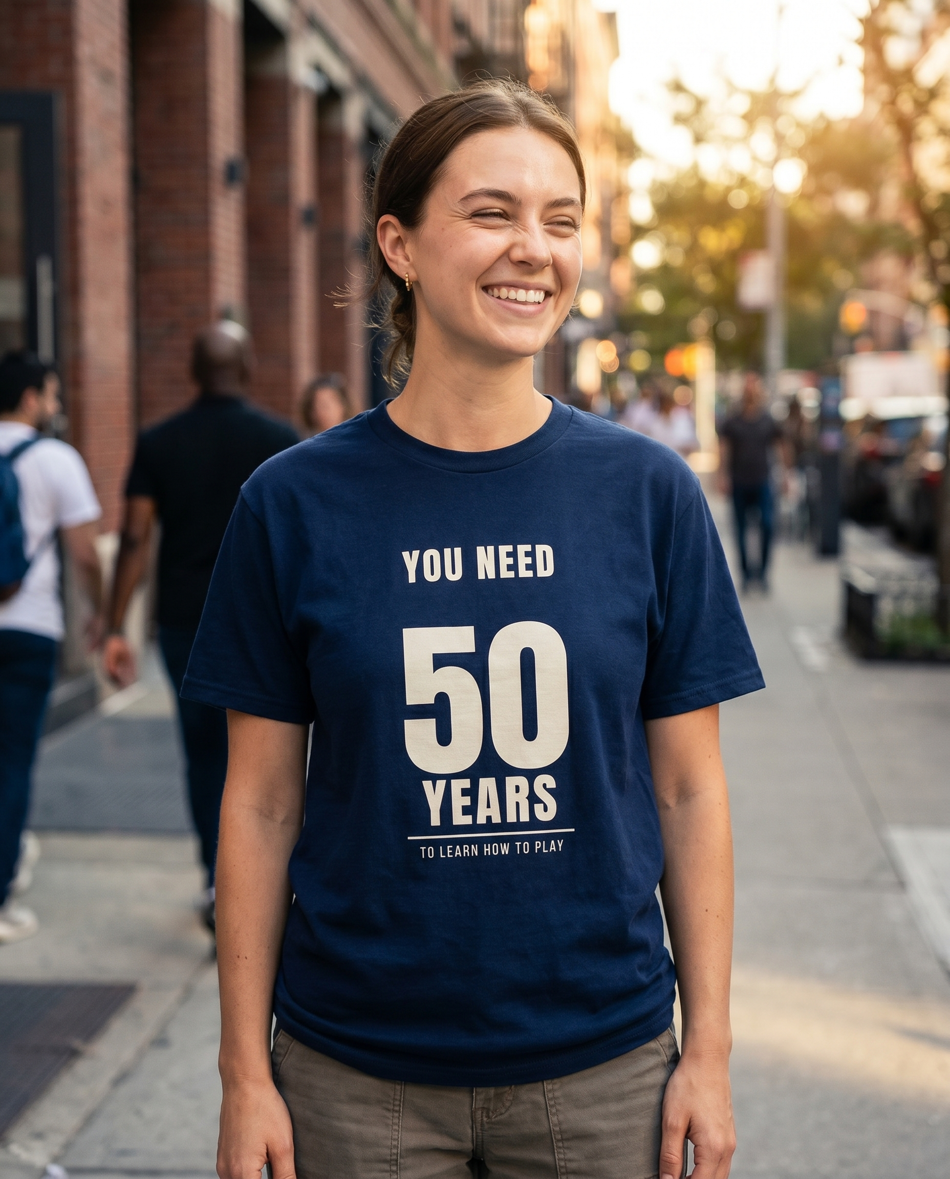 Model wearing You Need 50 Years navy tee outdoors