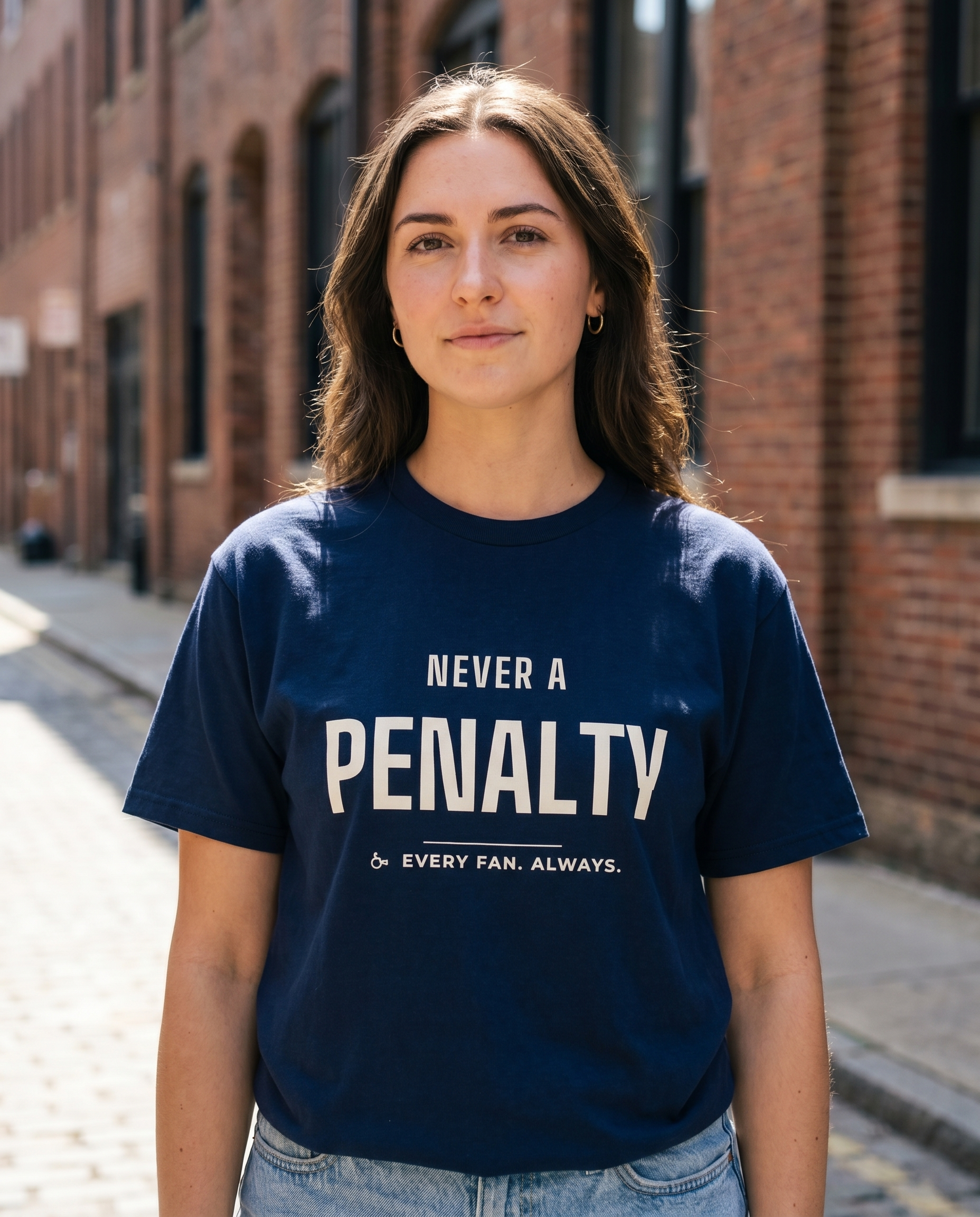Model wearing Never A Penalty navy tee outdoors